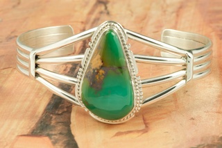 Genuine Royston Turquoise set in Sterling Silver Bracelet.  Created by Navajo Artist Kathy Yazzie. Signed by the artist. Royston Turquoise Mine was originally known as the Royal Blue Mine. It produces Turquoise that has a mixture of blues and greens in the same formation. The Royston Turquoise Mine is located in Nye County, Nevada. 